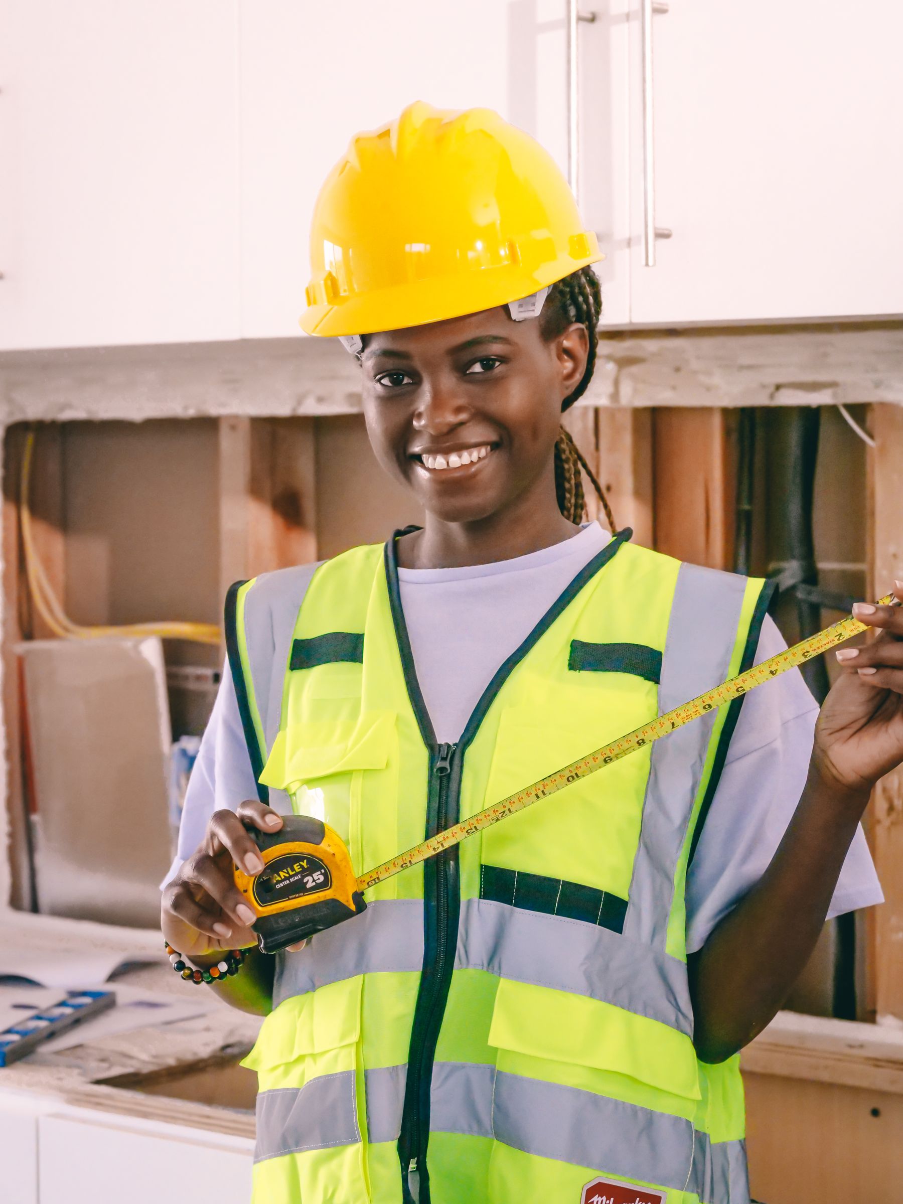 A local professional measuring a room during a walkthrough